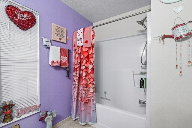 bathroom featuring shower / tub combo with curtain and a textured ceiling