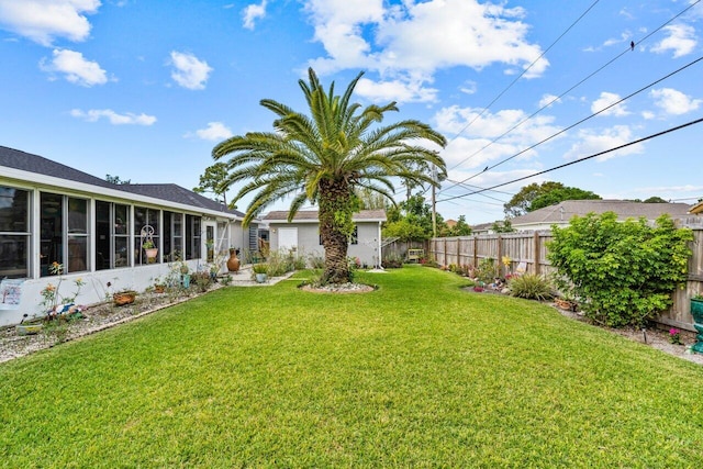 view of yard featuring a sunroom and fence