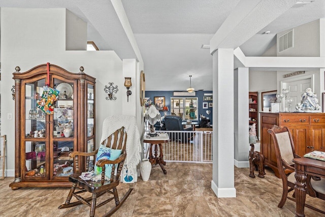 living area with visible vents and baseboards