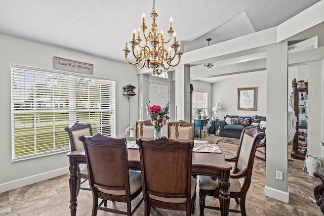 dining area featuring a notable chandelier, baseboards, and a textured ceiling