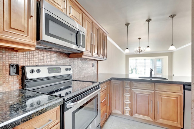 kitchen featuring light tile patterned floors, a sink, ornamental molding, appliances with stainless steel finishes, and tasteful backsplash