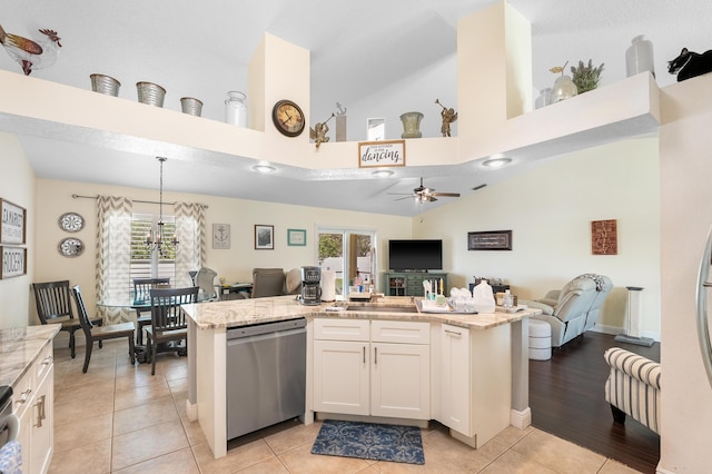 kitchen with white cabinets, dishwasher, an island with sink, open floor plan, and light tile patterned flooring