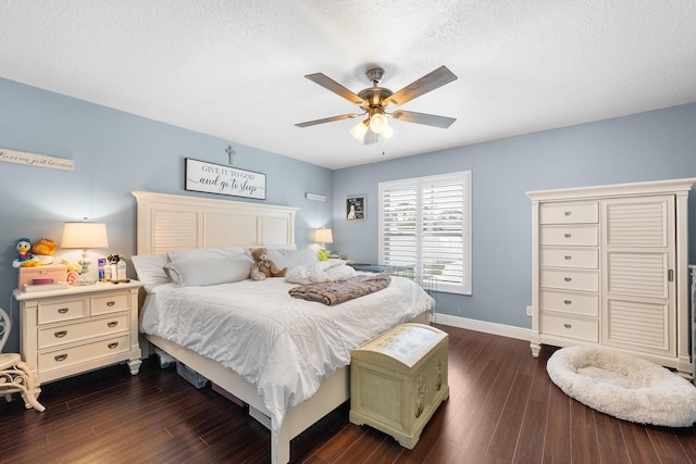 bedroom featuring a textured ceiling, baseboards, and dark wood-type flooring