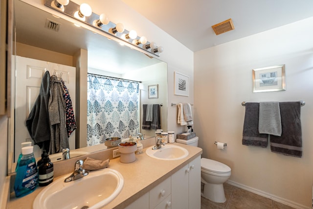 full bathroom with toilet, a sink, and visible vents