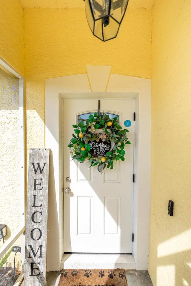 doorway to property with stucco siding