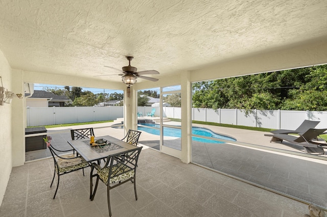 view of patio / terrace with a fenced in pool, a ceiling fan, area for grilling, a fenced backyard, and outdoor dining area