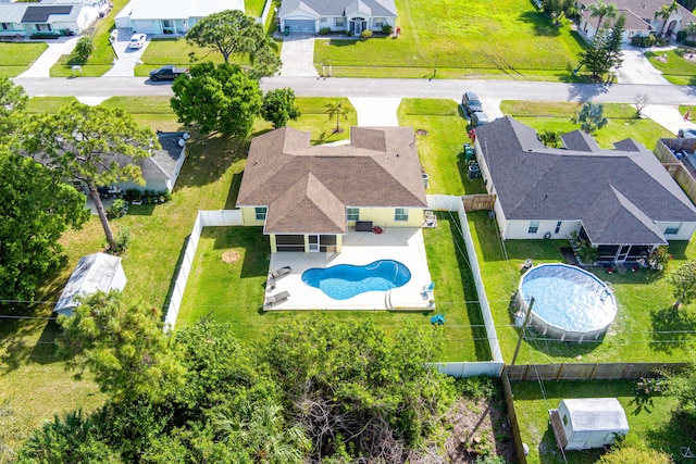 birds eye view of property with a residential view