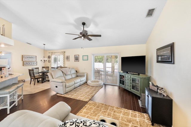 living area featuring lofted ceiling, ceiling fan, visible vents, and dark wood-type flooring