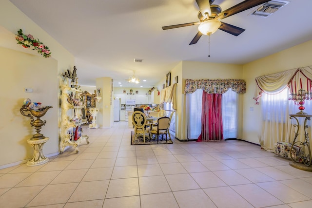 interior space with a ceiling fan, visible vents, and light tile patterned floors