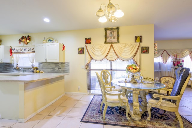 dining room with baseboards, an inviting chandelier, and light tile patterned floors