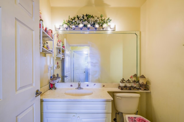 bathroom with toilet and vanity