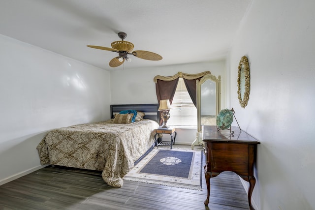 bedroom with ceiling fan, baseboards, and wood finished floors