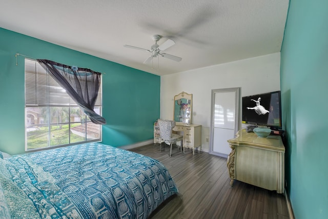 bedroom featuring dark wood-style floors, ceiling fan, a textured ceiling, and baseboards