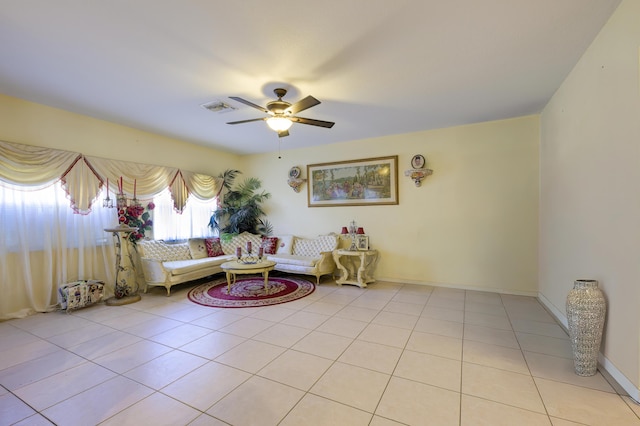 unfurnished living room featuring light tile patterned floors, baseboards, visible vents, and a ceiling fan