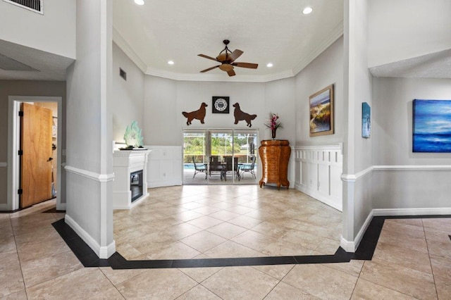 tiled entrance foyer with visible vents, baseboards, crown molding, and recessed lighting