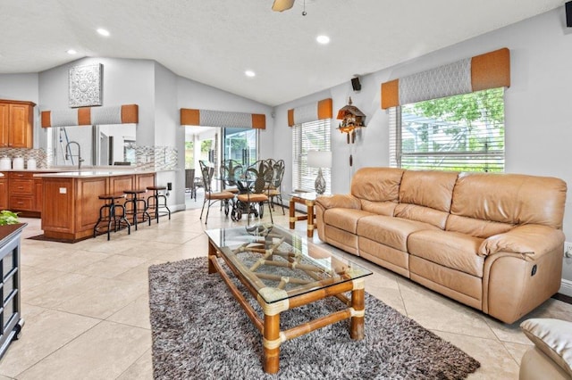 living room with lofted ceiling, a ceiling fan, and recessed lighting