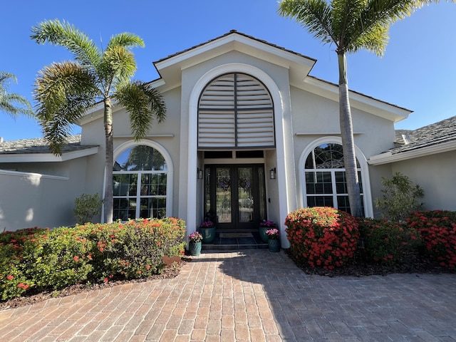 doorway to property with stucco siding and french doors