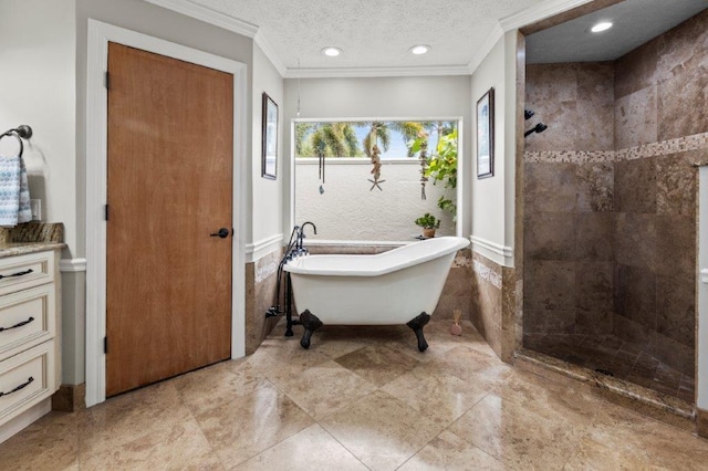 bathroom featuring crown molding, a freestanding tub, a tile shower, and a textured ceiling