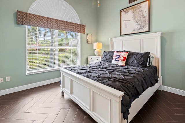 bedroom featuring parquet flooring, visible vents, and baseboards