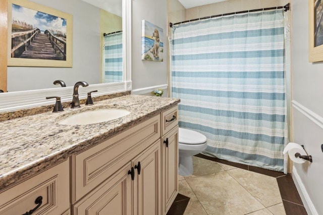 full bathroom featuring vanity, curtained shower, tile patterned flooring, and toilet