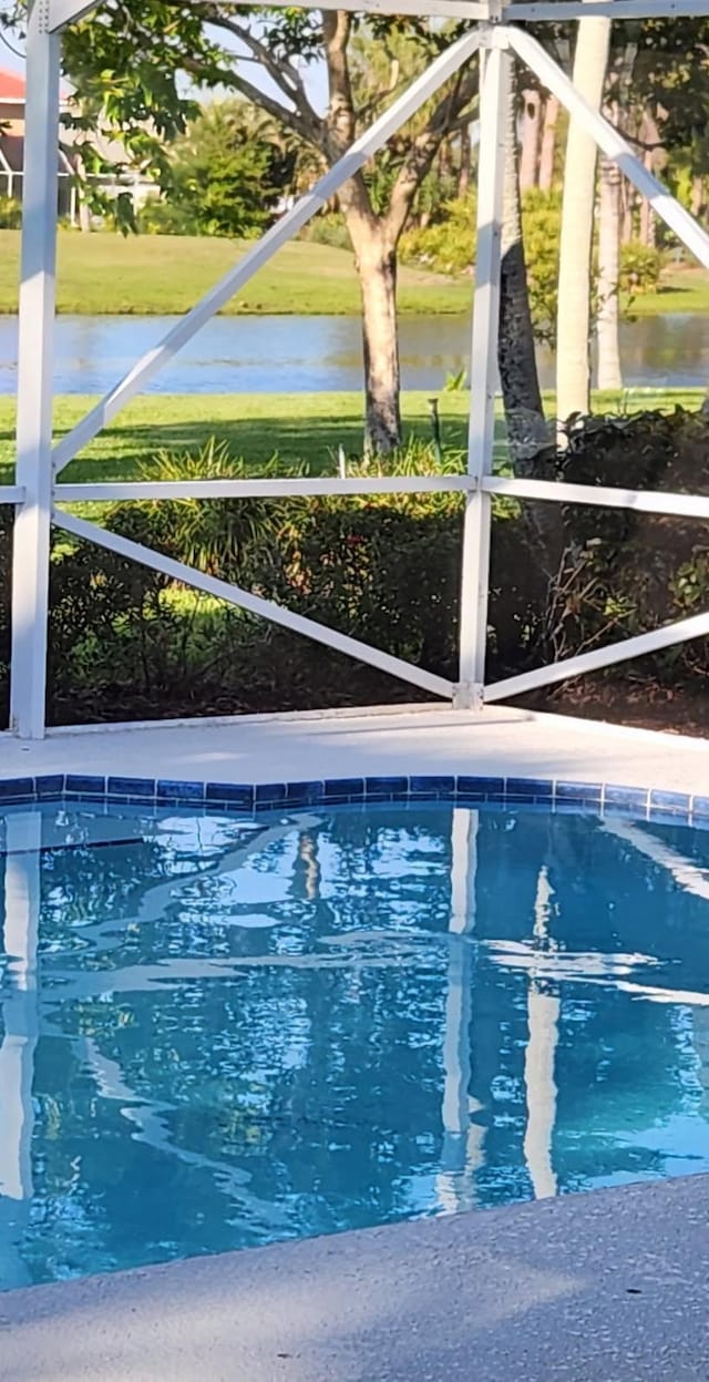 pool featuring a lanai and a water view