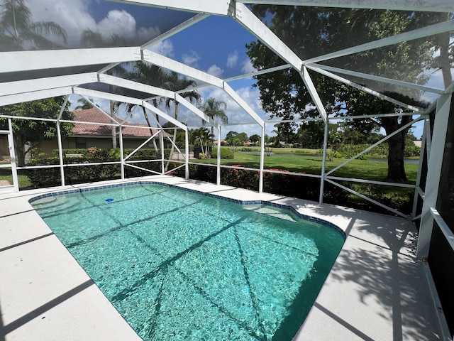 outdoor pool featuring a patio area and a lanai