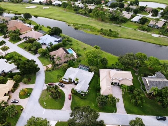 drone / aerial view with a water view and a residential view