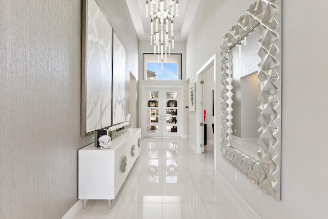 interior space featuring an inviting chandelier, baseboards, french doors, and light tile patterned flooring