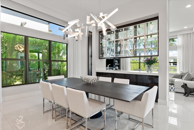 tiled dining area featuring a chandelier, a wealth of natural light, and recessed lighting