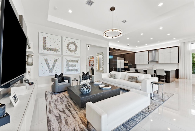 living area with recessed lighting, a raised ceiling, visible vents, and light tile patterned floors