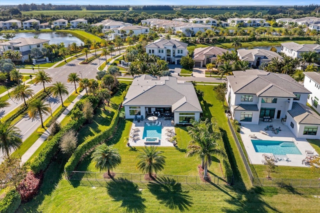 drone / aerial view featuring a residential view and a water view