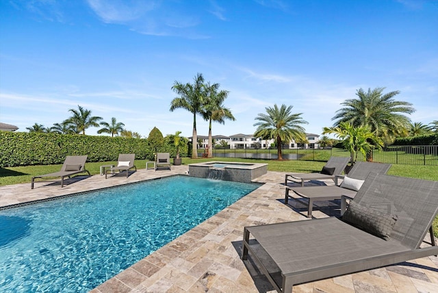 view of swimming pool with a pool with connected hot tub, a patio area, and fence