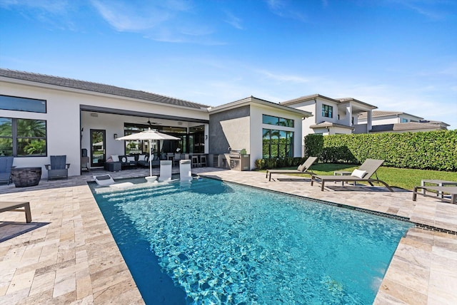 view of pool with a fenced in pool, an outdoor living space, a ceiling fan, and a patio