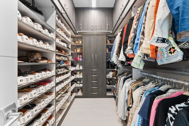 walk in closet with tile patterned floors