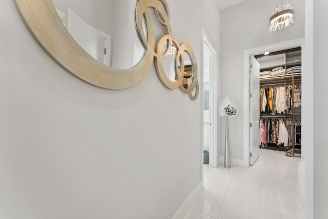 corridor with tile patterned flooring and baseboards