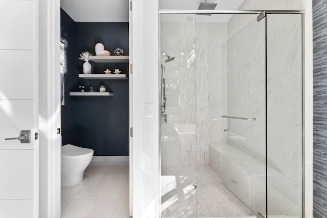 full bathroom with toilet, a stall shower, baseboards, and tile patterned floors