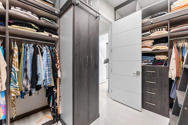 spacious closet featuring tile patterned flooring