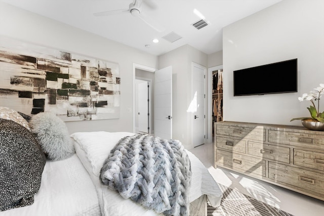 bedroom featuring ceiling fan, a spacious closet, a closet, and visible vents