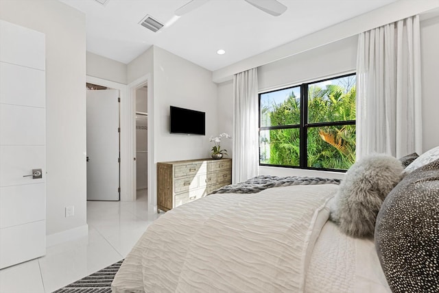 tiled bedroom with a ceiling fan and visible vents