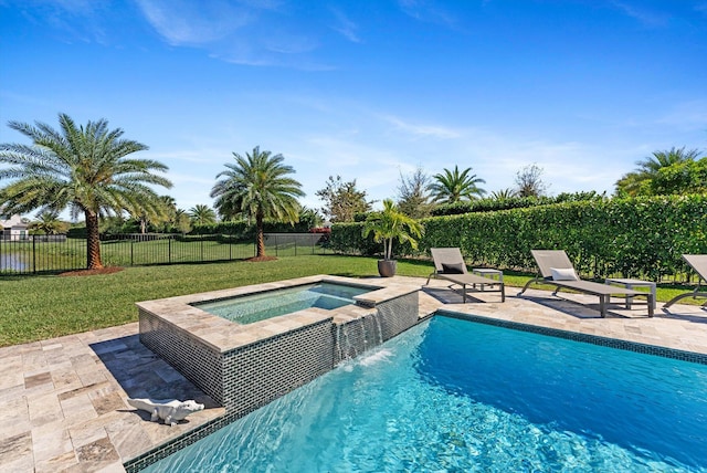 view of pool with an in ground hot tub, a yard, a patio area, and fence