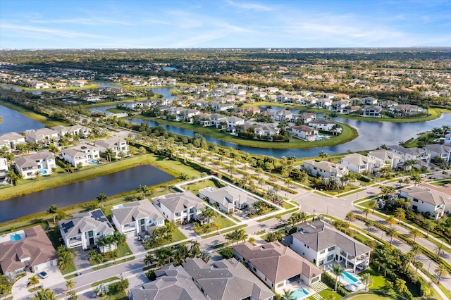 birds eye view of property featuring a water view and a residential view