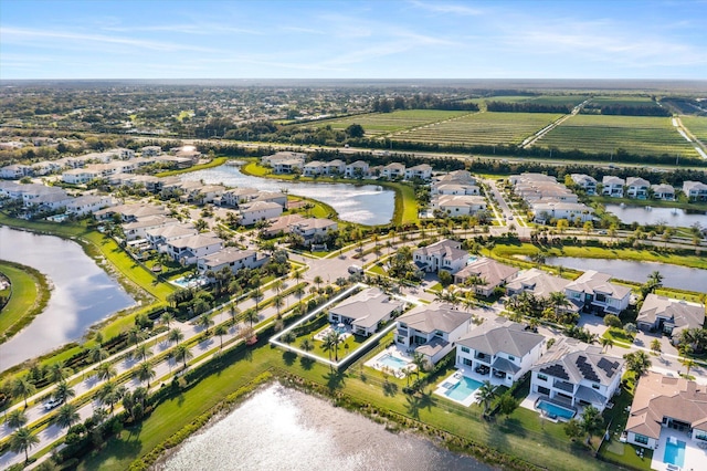 drone / aerial view featuring a water view and a residential view