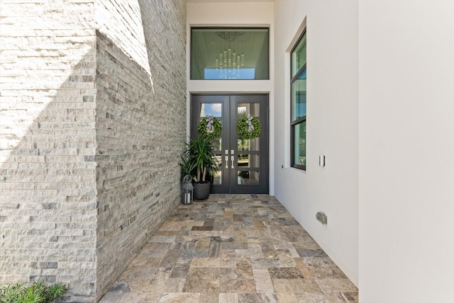 entrance to property with french doors and stucco siding