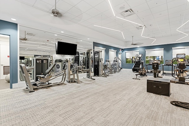 exercise room featuring a ceiling fan, carpet, visible vents, and a drop ceiling