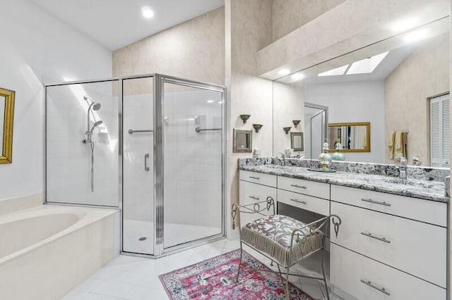 bathroom featuring a stall shower, vanity, and a bath