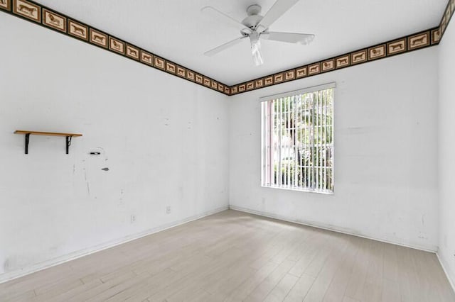 empty room with ceiling fan and wood finished floors