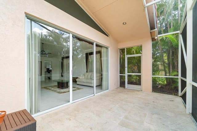 unfurnished sunroom featuring lofted ceiling