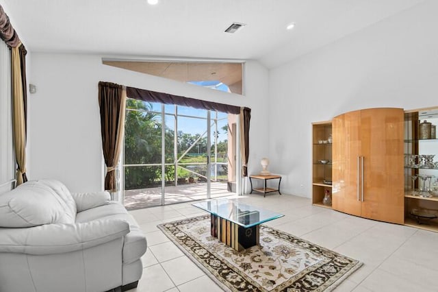 living room featuring lofted ceiling, light tile patterned floors, visible vents, and recessed lighting