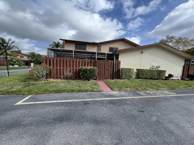 view of front of home with fence and stucco siding