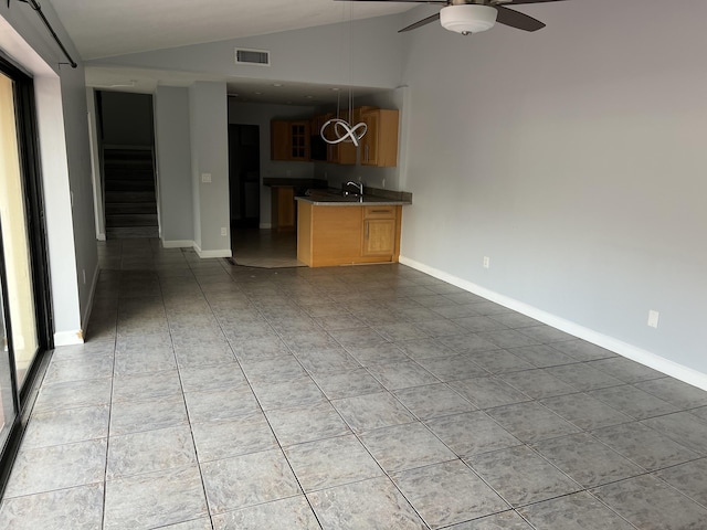 unfurnished living room featuring light tile patterned floors, lofted ceiling, visible vents, stairway, and ceiling fan